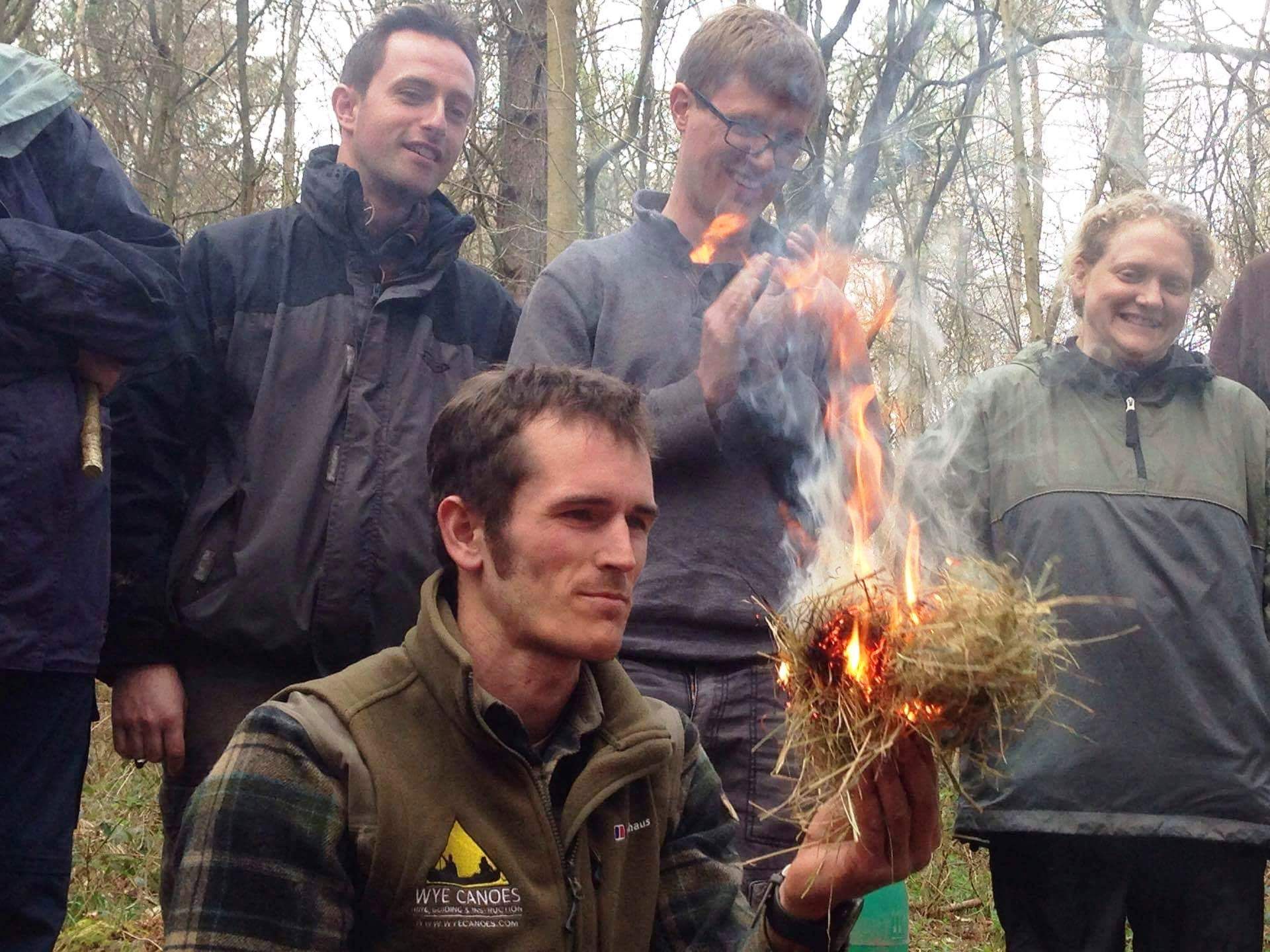 A Wye Adventures instructor demonstrating fire by friction.