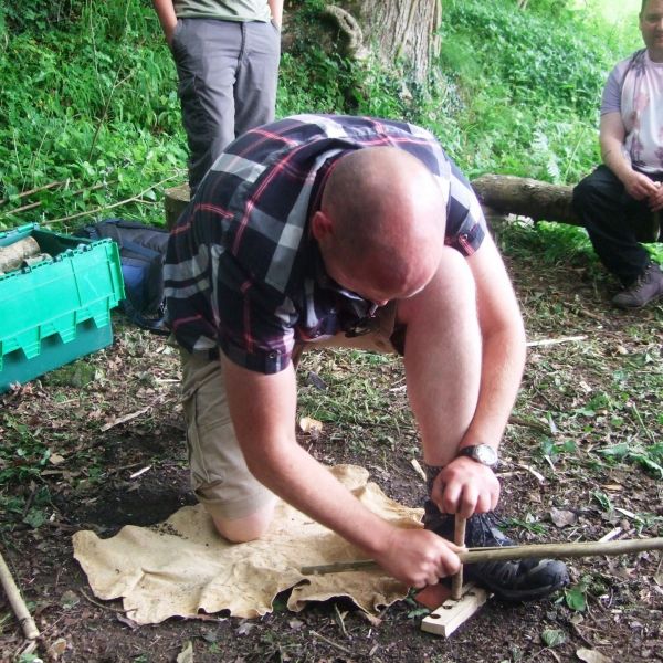 Learning how to use bow drill in a bushcraft session.